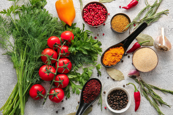 Different spices, vegetables and herbs on light background - Photo, image