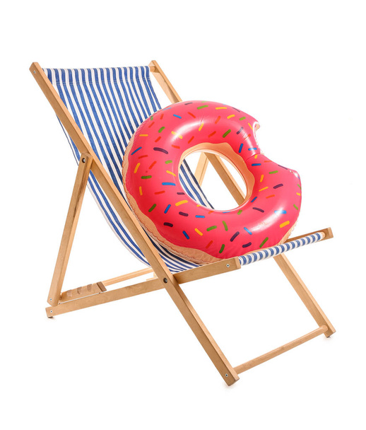 Striped deck chair with inflatable ring on white background - Photo, Image
