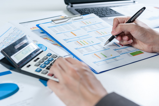 Businessman using calculator analyze report - Photo, Image