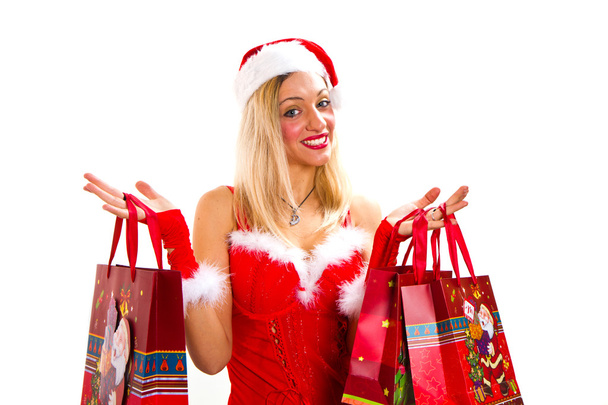 cheerful christmas woman in santa's wear smiling and holding sho - 写真・画像