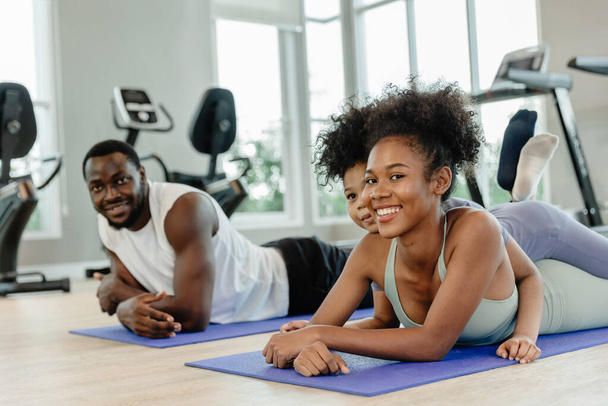 Black family teen parent with children exercise activity for healthcare together at fitness sport club. - Foto, Imagen