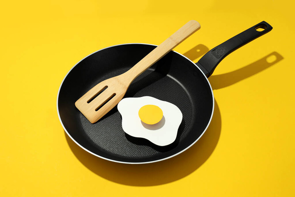 Concept of cooking on yellow background, fried egg - Fotoğraf, Görsel