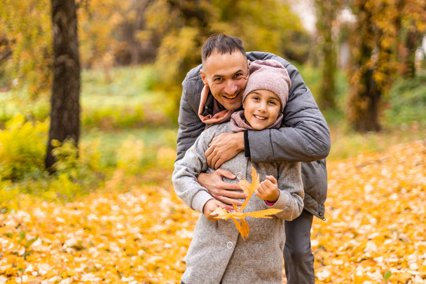 Happy father with daughter in fall season. - Photo, image