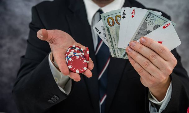 rich business man holding dollar and play card for poker game. good luck - Fotoğraf, Görsel