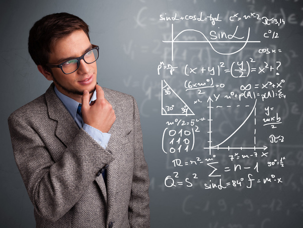 Handsome school boy thinking about complex mathematical signs - Foto, afbeelding