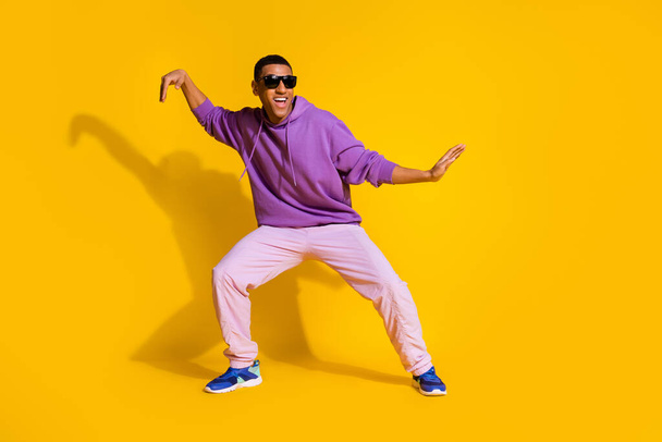 Full length body size view of attractive cheerful guy fooling dancing clubbing isolated over bright yellow color background. - Fotoğraf, Görsel