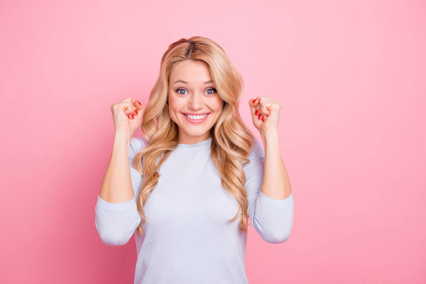 Photo of charming lucky lady dressed blue shirt smiling rising arms empty space isolated pink color background. - 写真・画像