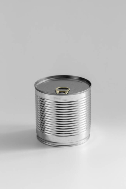 food storage and eating concept - close up of tin can with preserve on table - Fotografie, Obrázek