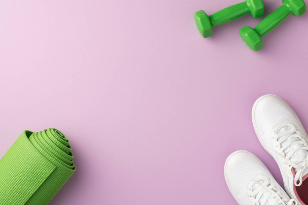 Fitness accessories concept. Top view photo of green yoga mat dumbbells and white sports shoes on isolated pastel violet background with copyspace - Foto, imagen
