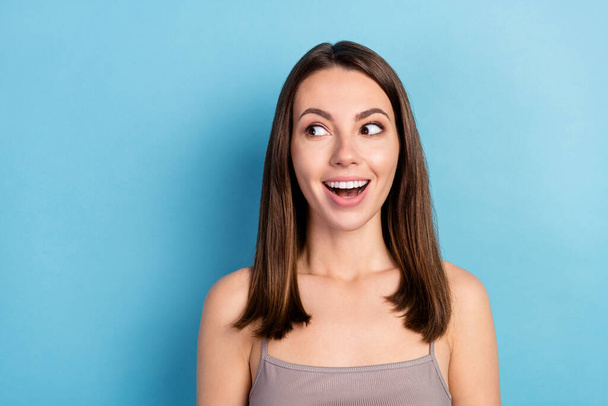 Portrait of attractive amazed cheerful girl looking aside copy empty blank space good news isolated over blue color background. - Foto, afbeelding