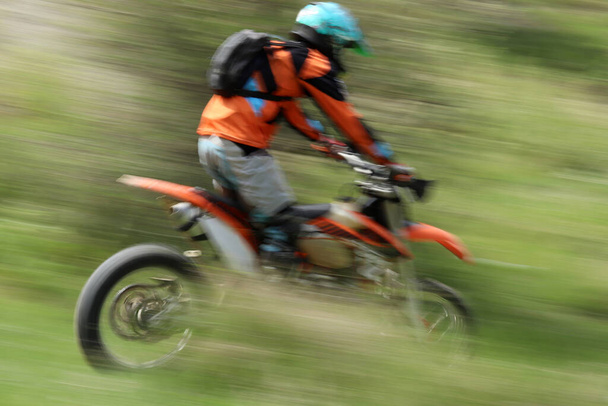 Blurry image of motorcycle riders during motocross race - 写真・画像
