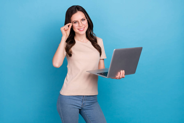 Photo of cheerful young businesswoman surfing social media find investors isolated on blue color background. - Foto, afbeelding