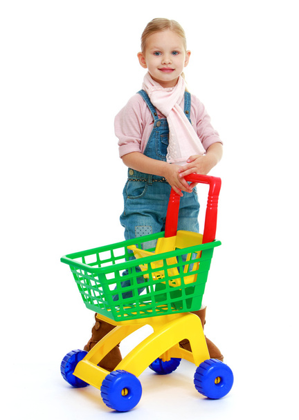 Charming little girl with a toy truck. - Foto, imagen