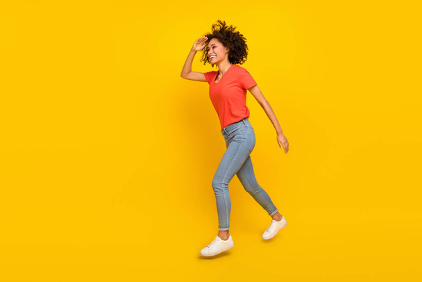 Full body profile portrait of excited attractive lady hand forehead look empty space isolated on yellow color background. - 写真・画像