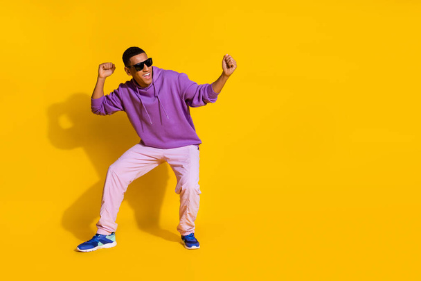 Full length body size view of attractive guy having fun dancing clubbing copy space isolated over bright yellow color background. - Valokuva, kuva