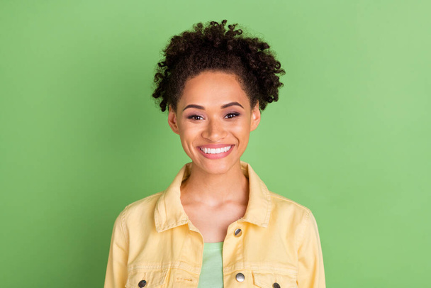 Photo of optimistic millennial brunette lady wear yellow shirt isolated on green color background. - Photo, image