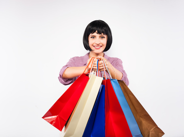 young brunette woman with shopping bags - Фото, изображение