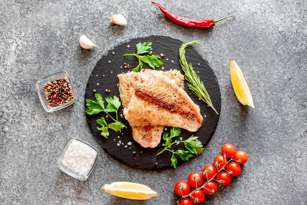 smažené rybí filety se zeleninou a kořením na talíři - Fotografie, Obrázek