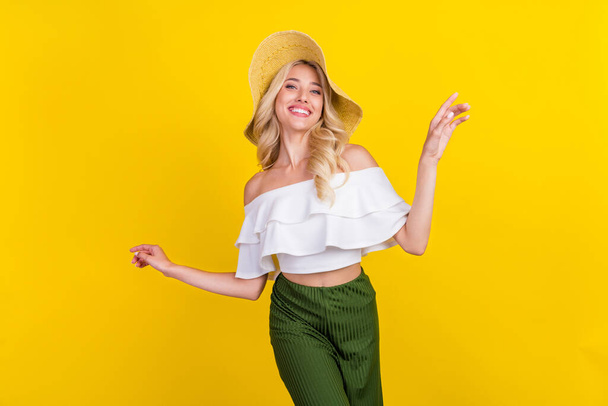 Photo of young cheerful woman happy positive smile headwear summer vacation isolated over yellow color background. - Fotoğraf, Görsel