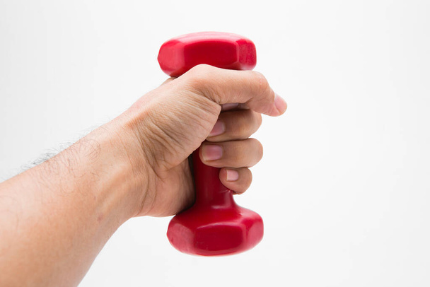 Red rubber coated dumbbell in hand isolated on white background. - Fotoğraf, Görsel