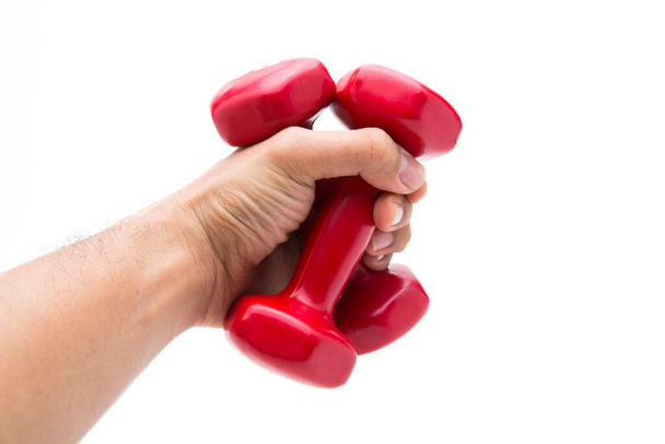 Red rubber coated dumbbell in hand isolated on white background. - Zdjęcie, obraz