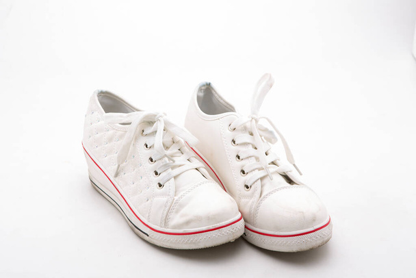 Pair of new white sneakers on white background - Foto, Imagen