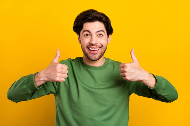 Photo of young cheerful charming man make thumbs up good mood smile isolated on yellow color background. - Fotoğraf, Görsel