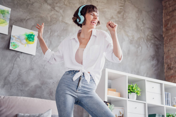 Portrait of attractive funny cheerful girl listening melody pretending singing hit single having fun at home loft interior indoors. - Photo, image
