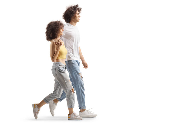 Full length profile shot of a boyfriend and girl walking together - Φωτογραφία, εικόνα
