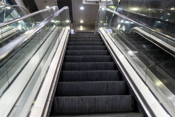 Modern escalator electronic system inside a building. Escalator in Community Mall, Shopping Center. Subway - Foto, afbeelding