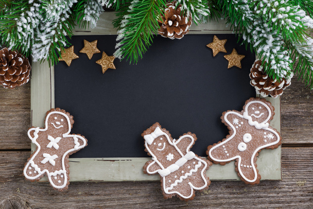 Christmas concept. Black board for text and gingerbread man - Foto, Imagen
