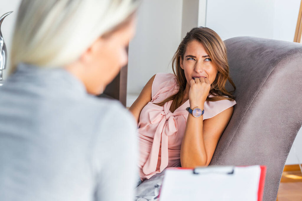 Woman at therapy session. Attentive psychologist. Young woman at psychotherapy thinking about advice she received - Foto, immagini