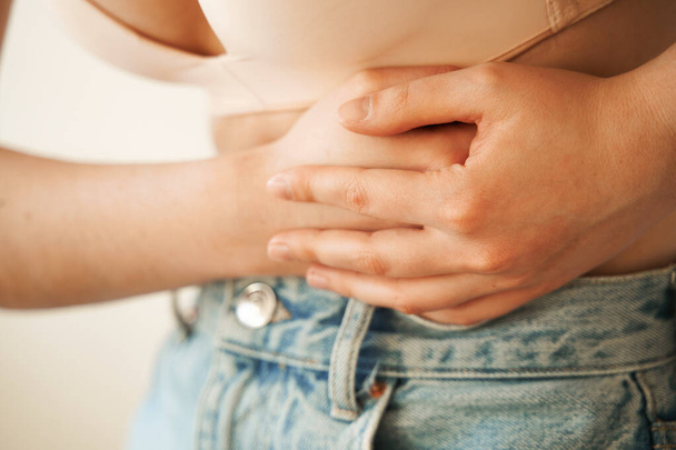 Stomach pain. Pancreatitis disease of pancreas becomes inflamed. Sick girl hold abdomen because it hurts - Fotó, kép