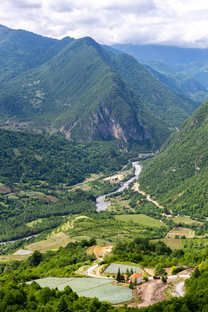 Tskhenistsqali river valley landscape in Racha region of Georgia with Svaneti mountain range, lush green forests and vineyards seen from to Khvamli Mountain. - Foto, imagen