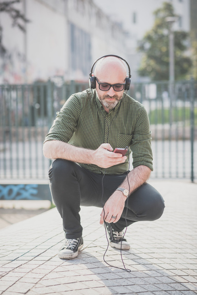 Красивий чоловік середнього віку слухає музику
 - Фото, зображення