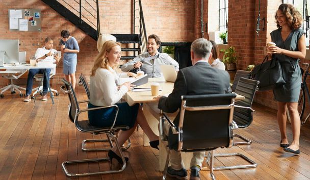 Shot of a group of businesspeople having a meeting in an office. - 写真・画像
