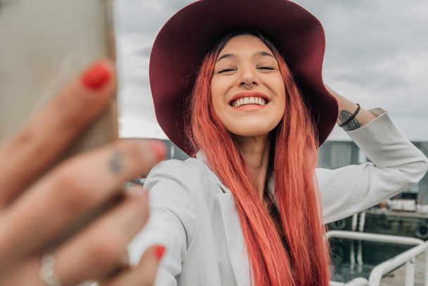 redhead influencer with mobile phone recording or taking photo - Zdjęcie, obraz