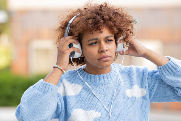 african american girl with headphones outdoors - Fotó, kép
