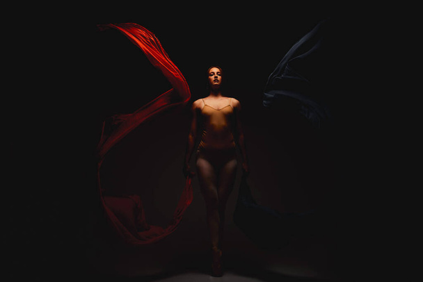 Shot of a performer dancing against a dark background. - Photo, Image