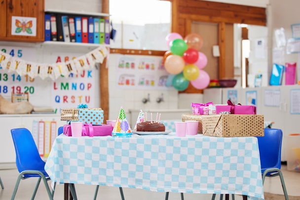 Shot of an empty class room decorated for a birthday party. - Foto, imagen
