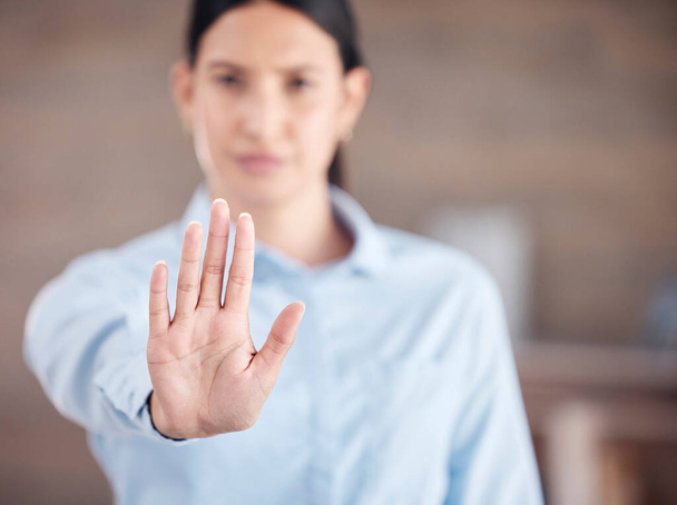 Closeup of of the hand of a mixed race business man gesturing stop while standing in her office. Stop gender based violence and sexual harassment in the workplace. Take a stand. Enough is enough. - Foto, Imagem