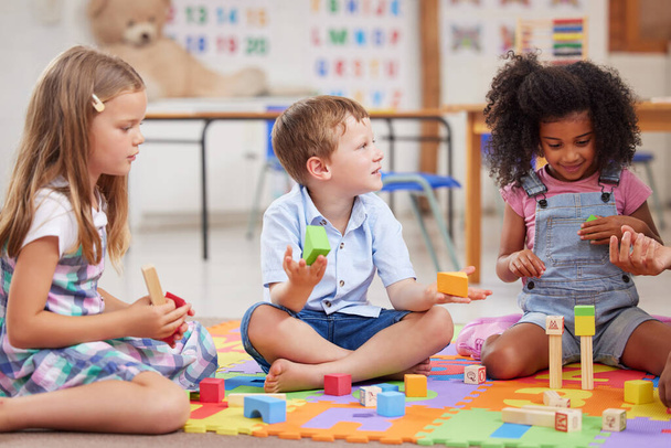 Shot of a group of preschool students playing together. - Foto, Imagem