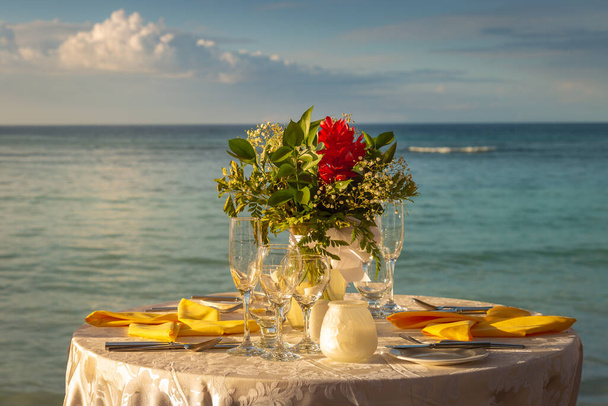 Romantic dinner: table for two and Beach with bouquet Montego Bay - Jamaica - Photo, Image