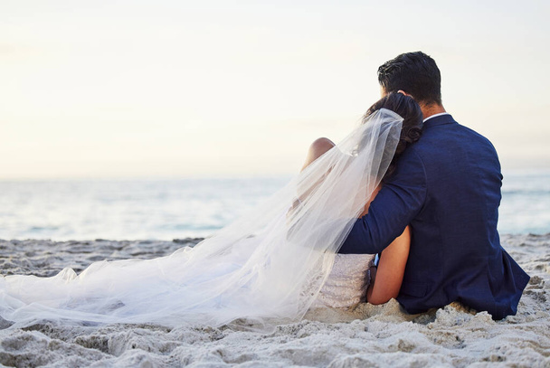 Shot of a young couple on the beach on their wedding day. - Photo, Image