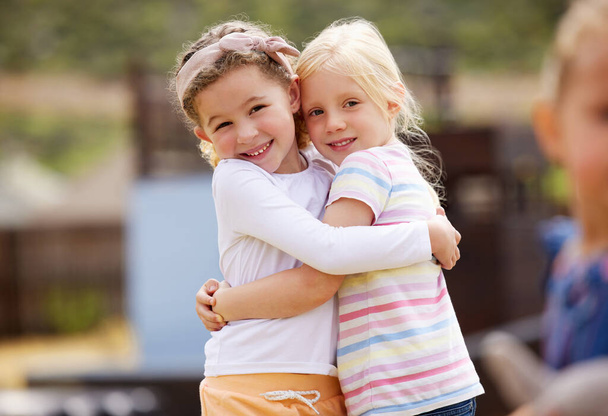 Shot of two little girls standing together outside. - Foto, Imagen