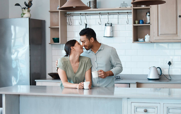 Shot of a young couple having a cup of coffee together at home. - Foto, Imagen