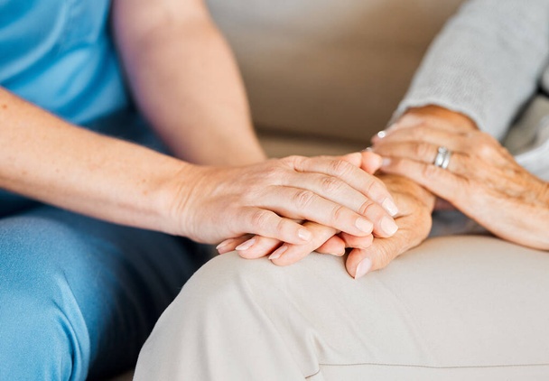 Closeup shot of an unrecognisable nurse holding a senior womans hand in comfort. - Photo, image