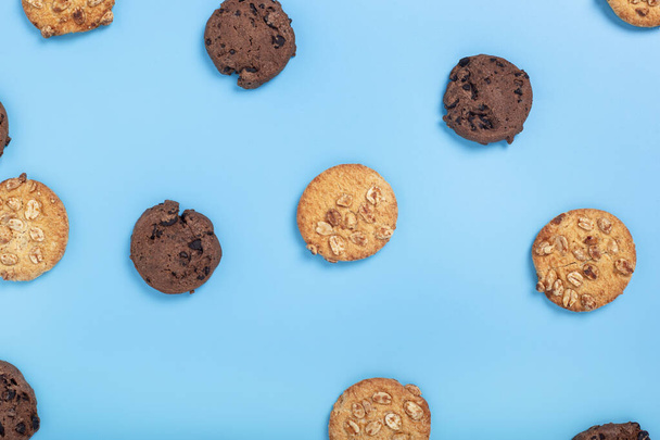 Chocolate cookies with chocolate, cookies with nuts on a blue background. Top view, flat lay - Фото, изображение
