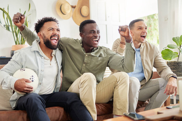 Shot of three male friends watching something together while sitting on a couch. - Φωτογραφία, εικόνα