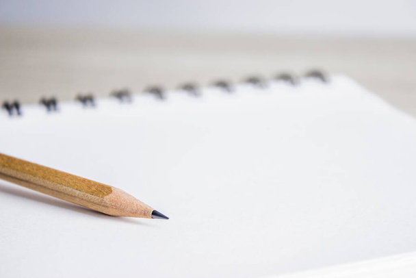 close-up of a notepad with pencil, pen, pens on a light background - Fotó, kép